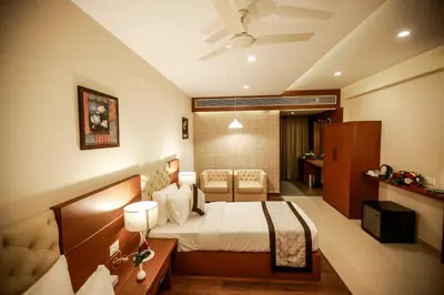 a hotel room with a bed in a room at Nesma Palace in Kannur