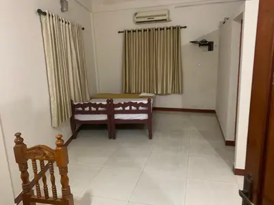 a living room with a bench and a window at Jinan city centre in Alwaye