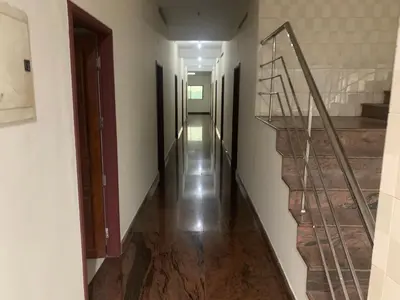 a hallway with stairs and a stair case at Jinan city centre in Alwaye