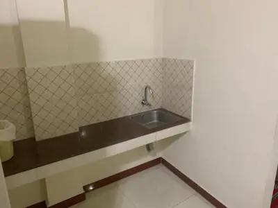 a bathroom with a sink and a tiled wall at Jinan city centre in Alwaye