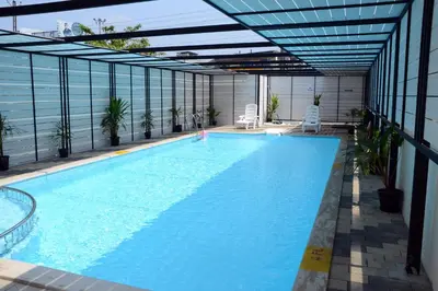 a swimming pool on the side of a building at Diana Heights Luxury Hotel in Nedumbassery