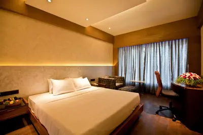 a hotel room with a bed and a window at Diana Heights Luxury Hotel in Nedumbassery