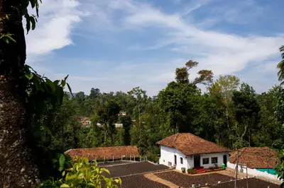 a small white house with a roof at Zostel Coorg, Madikeri in Madikeri