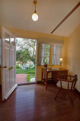 an open door to a room with a desk and a chair at Gateway Coonoor in Coonoor