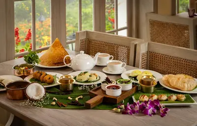 a table with plates of food on top at Gateway Coonoor in Coonoor