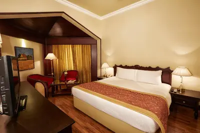a hotel room with a bed and a television at The Gateway Hotel Beach Road, Calicut in Kozhikode