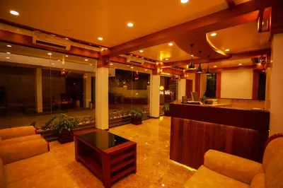 a living room with a couch and a table at Zubis Inn Hotel in Kalpetta
