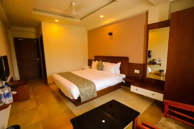 a bedroom with a bed and a large mirror at Zubis Inn Hotel in Kalpetta