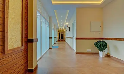 a hallway of a building with a hallway at Treebo Golden Terminal Kochi Airport With Swimming Pool in Cochin