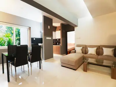 a living room with a couch and a table at Transit Suites by GrandWest in Nedumbassery