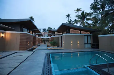 a house with a swimming pool in front of it at Lago Leisure Resort & Spa in Cherai Beach