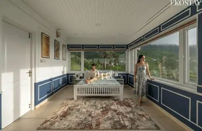 a man and a woman standing in a room with a bed at EKO STAY - Woodside Ivy in Ooty