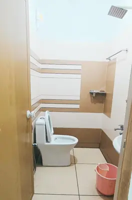 a bathroom with a toilet and a sink at THEKKUMPURAM RESIDENCY in Kondotti
