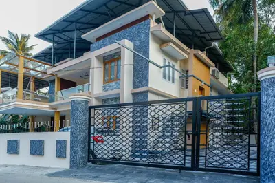 a house with a gate in front of it at Belljem Homes -your own private resort -1 BHK FF in Trichūr
