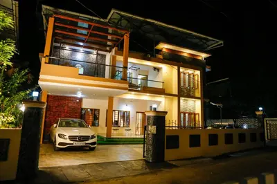 a car parked in front of a house at night at Belljem Homes -your own private resort -1 BHK FF in Trichūr