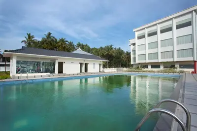 a swimming pool in front of a building at Blue Serene Backwater Resort in Guruvāyūr