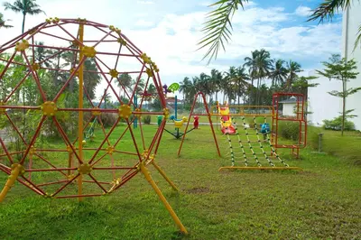 a park with a bunch of playground equipment in the grass at Blue Serene Backwater Resort in Guruvāyūr