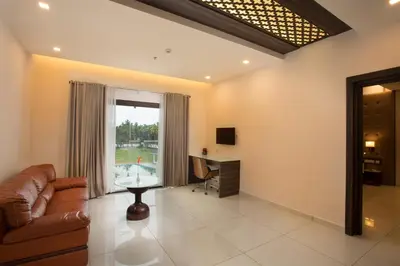 a living room with a couch and a desk at Blue Serene Backwater Resort in Guruvāyūr