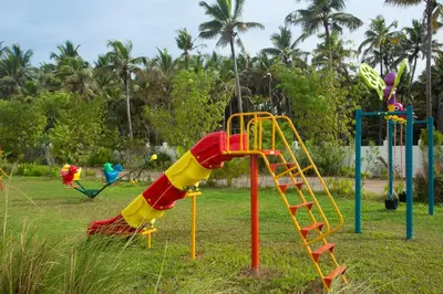 a playground with a slide in a park at Blue Serene Backwater Resort in Guruvāyūr