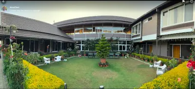 a large building with a garden in front of it at Radosri in Coonoor