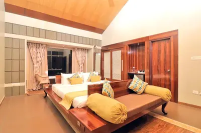 a bedroom with a large bed and a couch at Radosri in Coonoor
