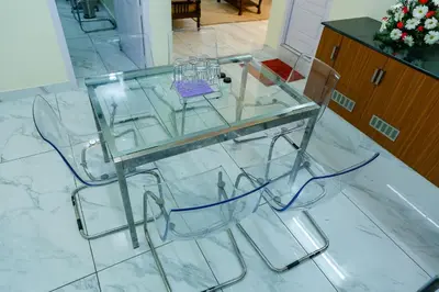a glass table sitting on top of a marble floor at Belljem Homes -your own private resort -7 BHK in Trichūr