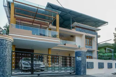 a house with a balcony with a fence at Belljem Homes -your own private resort -7 BHK in Trichūr