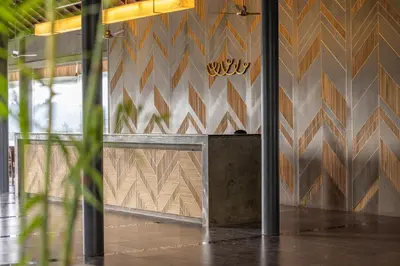a lobby with a bench in front of a wall at Saptha Resort and Spa in Sultan Bathery