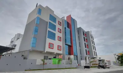a building with colorful windows on the side of it at Treebo Everest Residency Tidel Park, 15 Mins From Coimbatore International Airport in Coimbatore