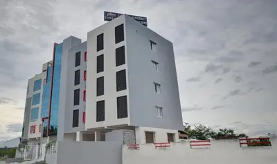 a white building with black windows on the side of it at Treebo Everest Residency Tidel Park, 15 Mins From Coimbatore International Airport in Coimbatore