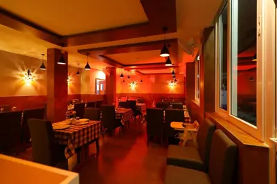 a restaurant with tables and chairs in a room at HOTEL LA SERENE Mattannur in Mattanūr