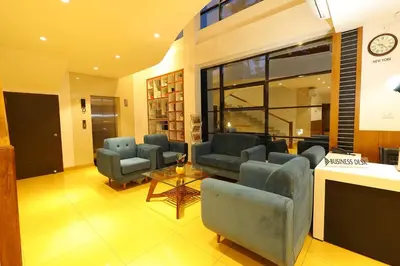 a living room with couches and chairs and a table at HOTEL LA SERENE Mattannur in Mattanūr