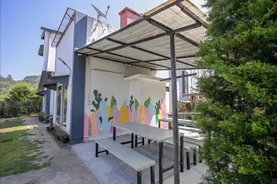 a picnic table and a mural on the side of a building at Rendezvous in Coonoor