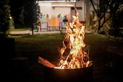 a fire pit with flames in it in a yard at Rendezvous in Coonoor
