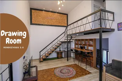 a room with a staircase and a book shelf at Rendezvous in Coonoor