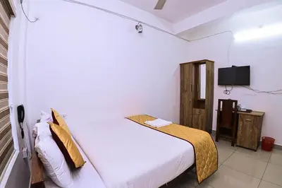 a bedroom with a bed and a tv in it at Nirupama,Hotel Aluva 700 Mtr From Aluva Railway Station in Alwaye