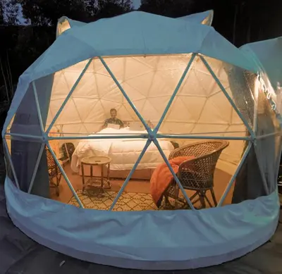 a man in a dome tent with a bed at Anandavana Jungle Living By LexStays - Kanthalloor-Marayur in Kanthalloor