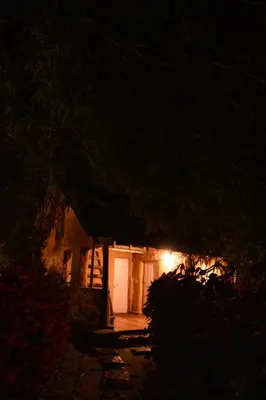 a house at night with a light on the door at Anandavana Jungle Living By LexStays - Kanthalloor-Marayur in Kanthalloor