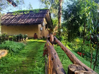 a wooden fence in front of a house at Anandavana Jungle Living By LexStays - Kanthalloor-Marayur in Kanthalloor