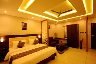 a hotel room with a large bed and a ceiling at MC Suites Mysuru in Mysore