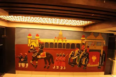 a painting on the wall of a room at MC Suites Mysuru in Mysore