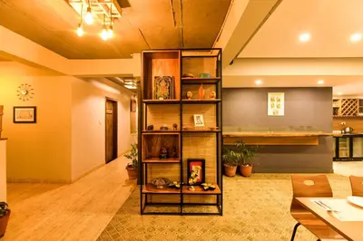 a living room with a book shelf at SAFARI QUEST in Mysore