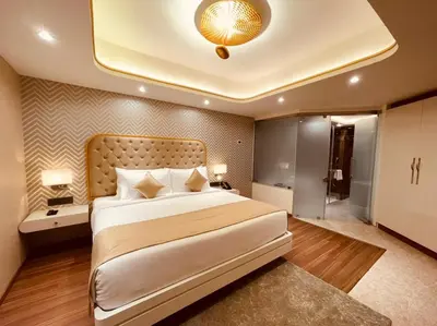 a bedroom with a large white bed with a large ceiling at Dimora Kozhikode in Kozhikode