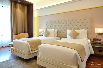 a hotel room with two beds in a room at Dimora Kozhikode in Kozhikode