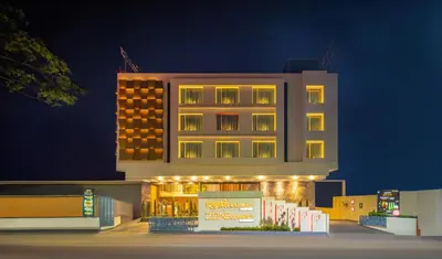 a tall building with lights on it at night at Zone Connect by The Park Coimbatore in Coimbatore