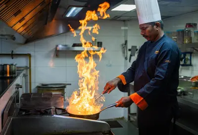 a chef cooking on a grill with a spatula at Zone Connect by The Park Coimbatore in Coimbatore