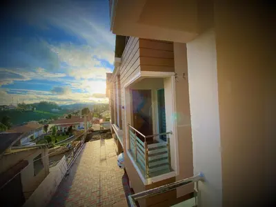 a balcony of a building with a view of a city at Avalon Stays in Ooty