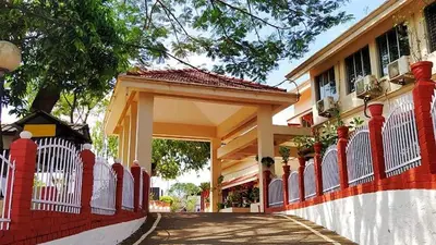 a house with a red and white fence at KTDC Tamarind, Mannarkkad in Alanallūr