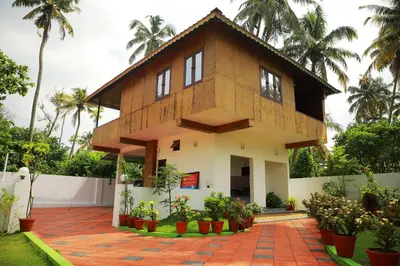a house with a lot of plants in front of it at Cherai Beach Residency in Cherai Beach
