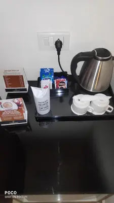 a table with a tea pot and other items on it at Emperor-Hotel Rachana Continental Pvt Ltd in Kizhake Chālakudi